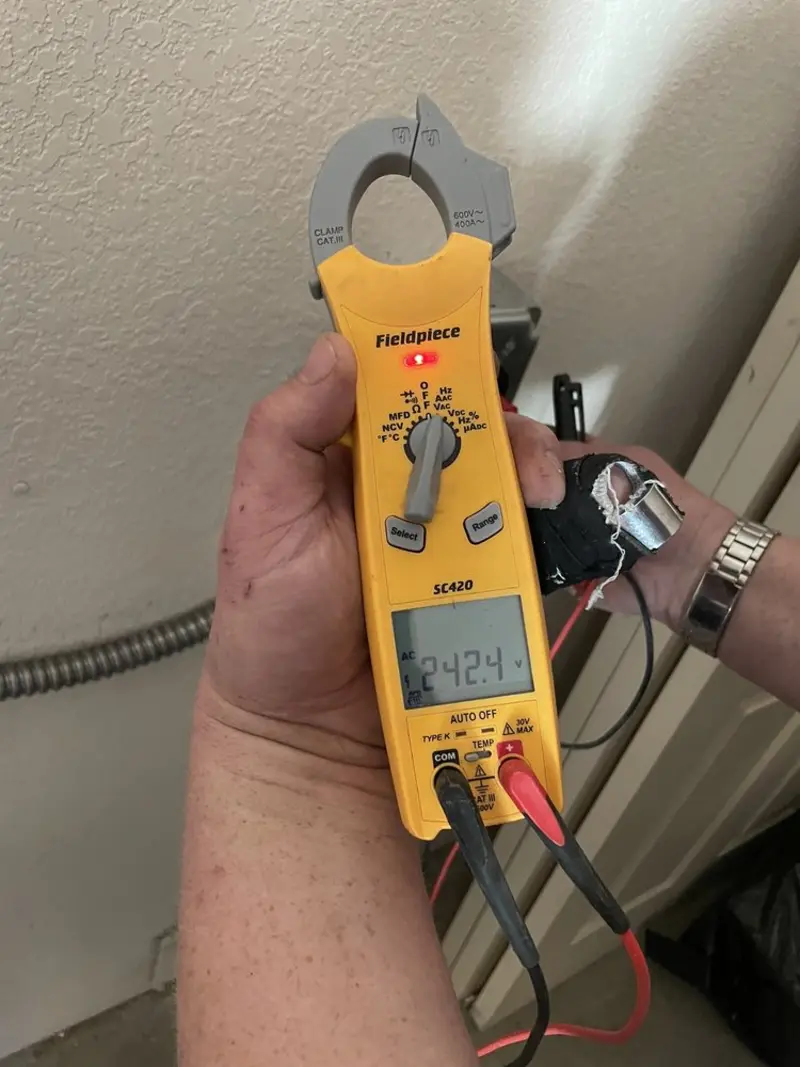 Voltage testing with clamp meter during Whole House Surge Protector in Green Forest